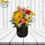 CAJA CILINDRICA BOMBONERA, MIX FLORAL ROSAS, GERBERAS, LILIUM Y 6 BOMBONES FERREROS ROCHER