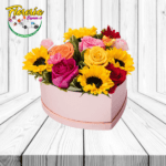 CAJA CORAZON  MIX FLORAL CON 5 ROSAS, 3 GIRASOLES Y 1 GERBERA